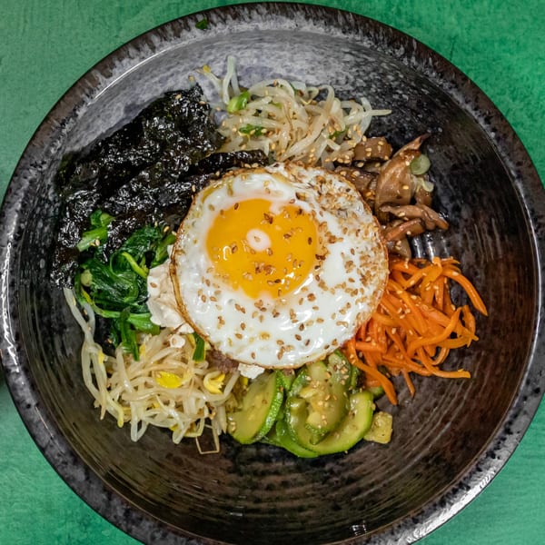 Komi Tofu's bibimbap with a fried egg, seaweed, spinach, carrots, zucchini, and bean sprouts.