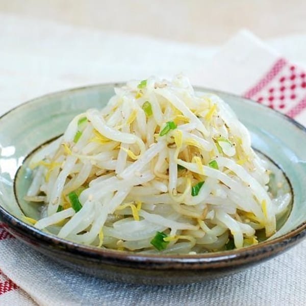 A bowl of Korean bean sprout salad (Kongnamul Muchim) with green onions.