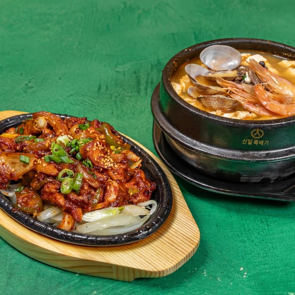 Korean spicy chicken stir-fry on a sizzling plate and a seafood soft tofu stew.